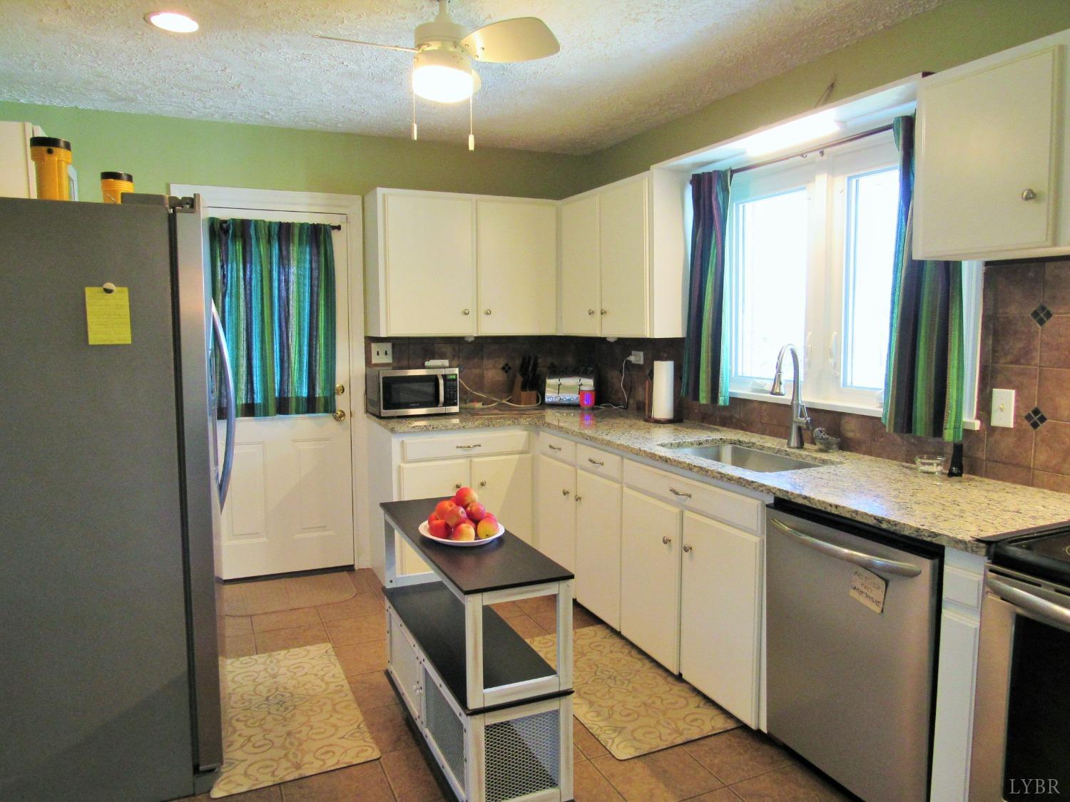 801 Gidsville Road Amherst, VA 24521 - Photo 9 of 34 a kitchen with granite countertop a sink stove and cabinets
