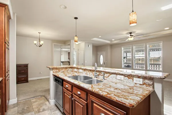 a bathroom with a granite countertop sink and a window