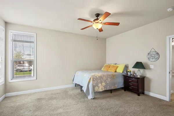 a bedroom with bed and a window
