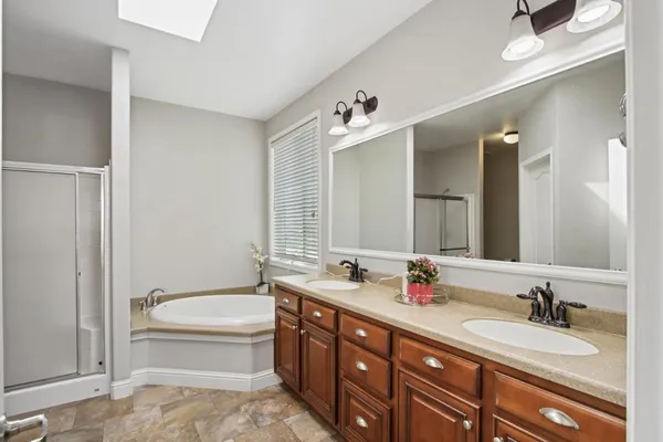 a bathroom with a granite countertop sink toilet and a mirror