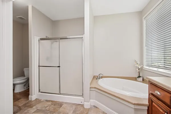 a bathroom with a tub and shower