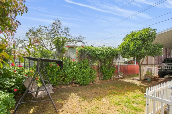 a view of a house with a patio and a yard