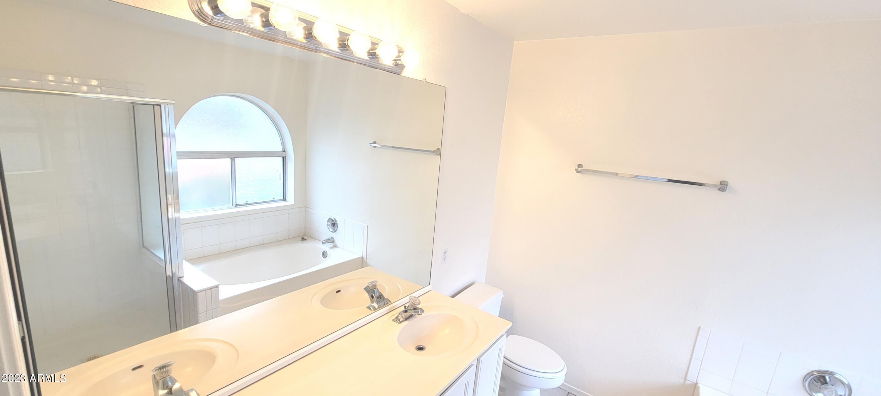 1202 North Bogle Avenue Chandler, AZ 85225 - Photo 9 of 16 a bathroom with a sink mirror and a toilet