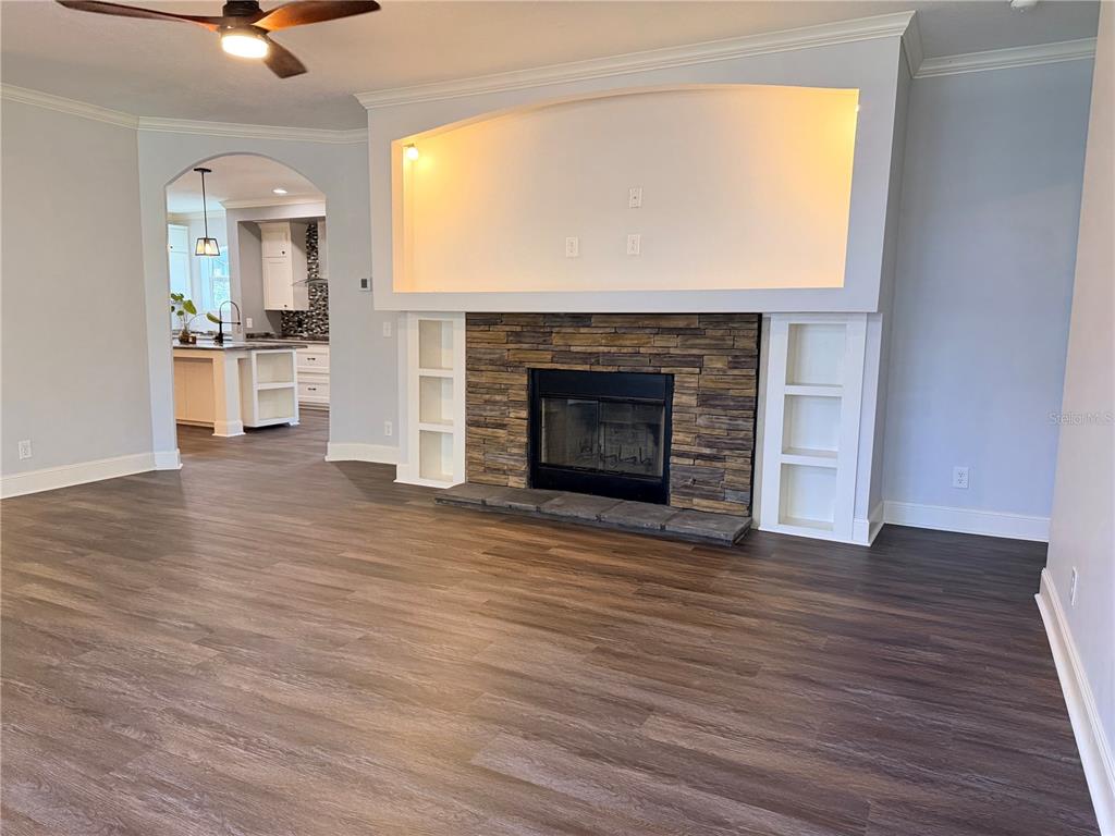 4440 Southwest 63rd Boulevard Gainesville, FL 32608 - Photo 12 of 49 a view of an empty room with wooden floor and a fireplace