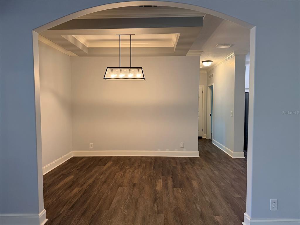 4440 Southwest 63rd Boulevard Gainesville, FL 32608 - Photo 22 of 49 a view of a room with wooden floor and chandelier