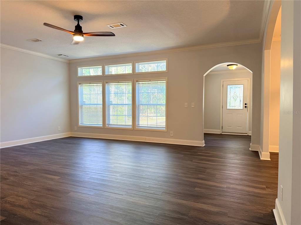 4440 Southwest 63rd Boulevard Gainesville, FL 32608 - Photo 23 of 49 a view of empty room with wooden floor and fan