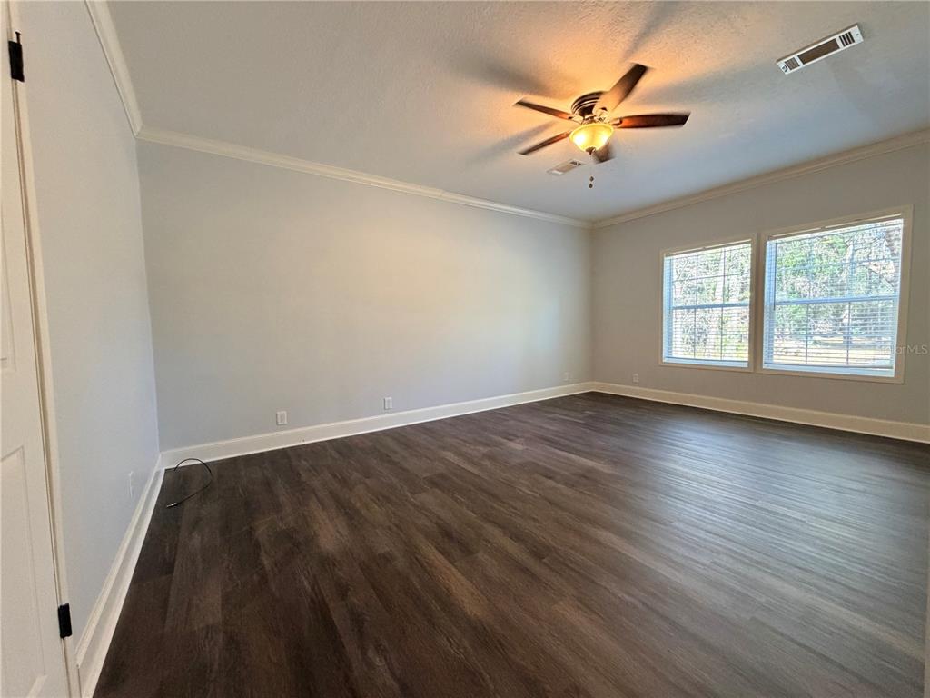 4440 Southwest 63rd Boulevard Gainesville, FL 32608 - Photo 25 of 49 wooden floor in an empty room with a window
