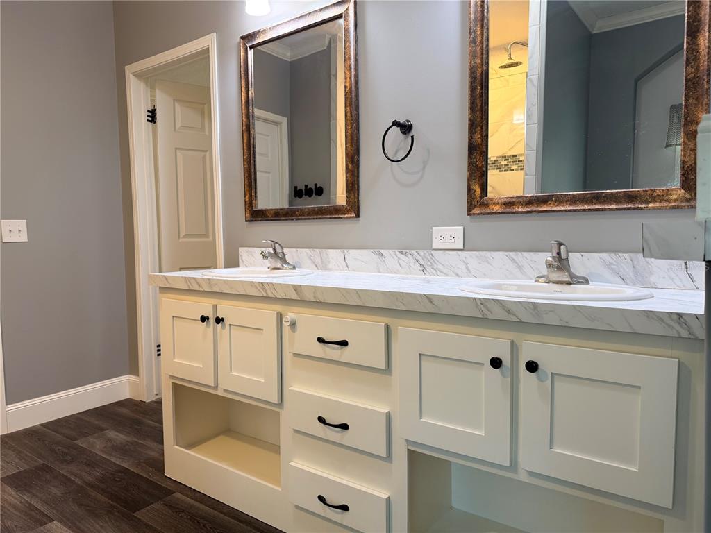4440 Southwest 63rd Boulevard Gainesville, FL 32608 - Photo 29 of 49 a bathroom with a double vanity sink and mirror