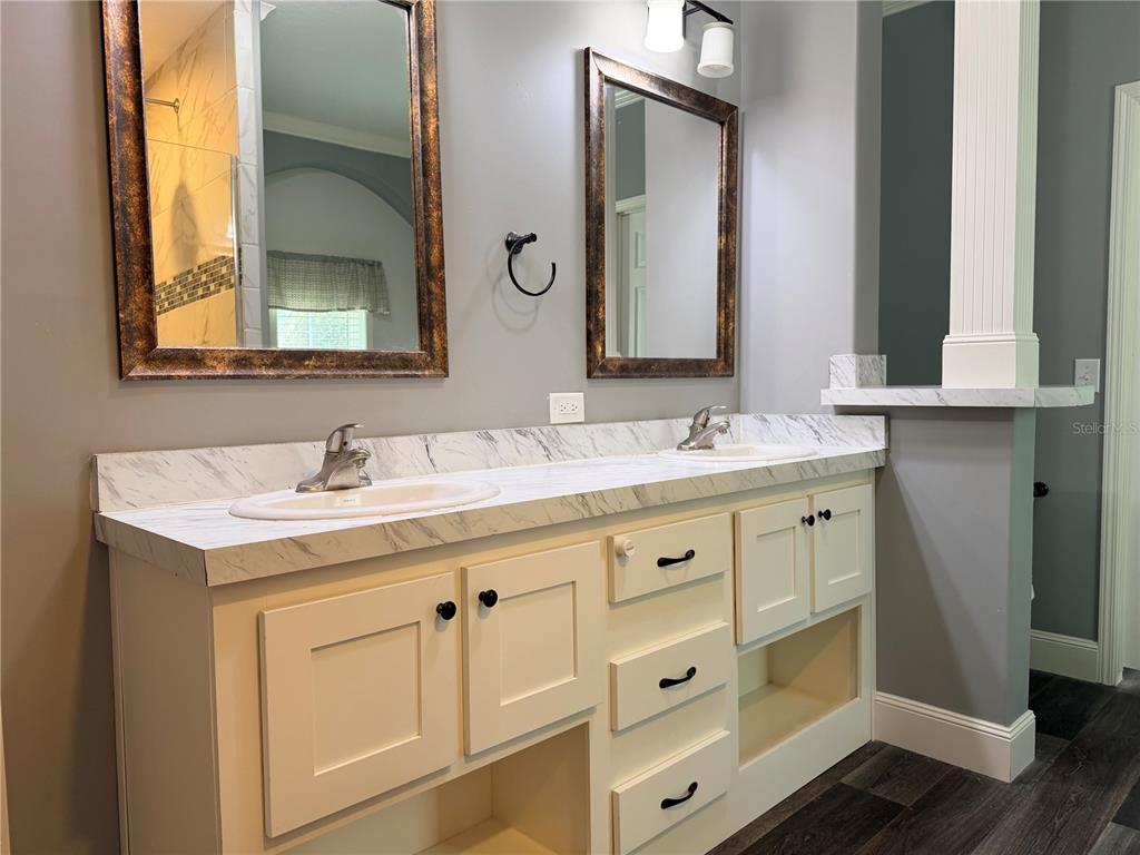 4440 Southwest 63rd Boulevard Gainesville, FL 32608 - Photo 32 of 49 a bathroom with double sink and a mirror