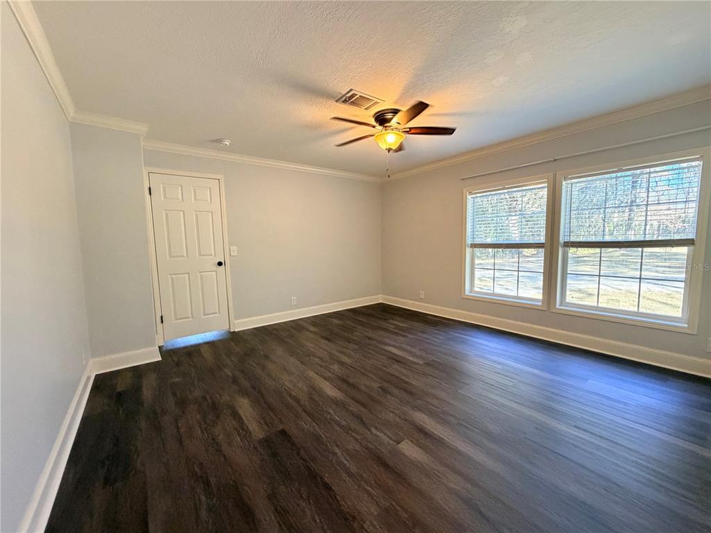 4440 Southwest 63rd Boulevard Gainesville, FL 32608 - Photo 34 of 49 a view of empty room with wooden floor and fan