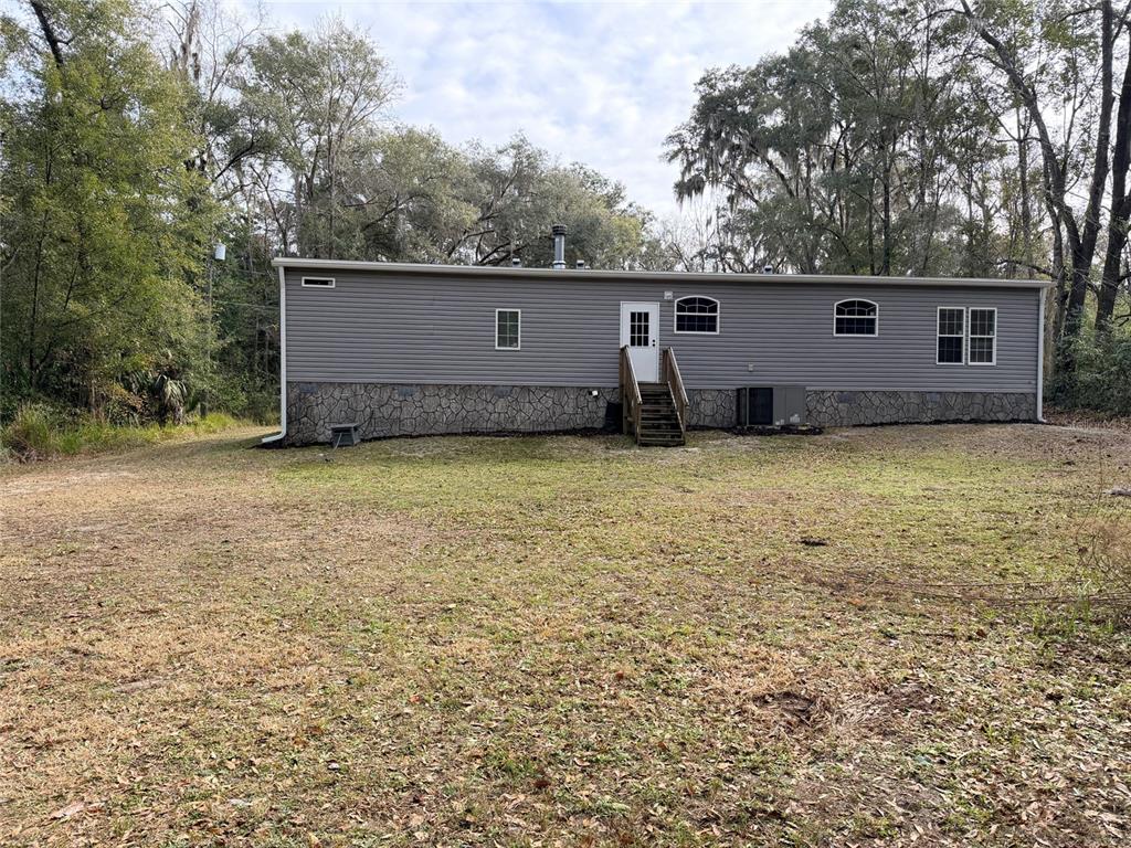 4440 Southwest 63rd Boulevard Gainesville, FL 32608 - Photo 47 of 49 a view of a house with a yard