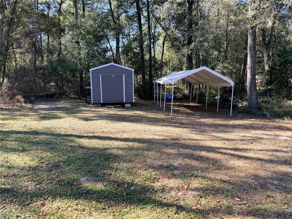 4440 Southwest 63rd Boulevard Gainesville, FL 32608 - Photo 48 of 49 a backyard of a house with table and chairs