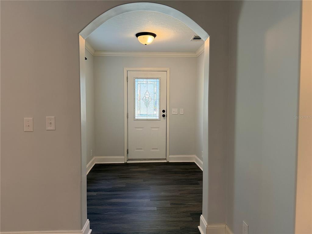 4440 Southwest 63rd Boulevard Gainesville, FL 32608 - Photo 8 of 49 a view of an entryway with wooden floor