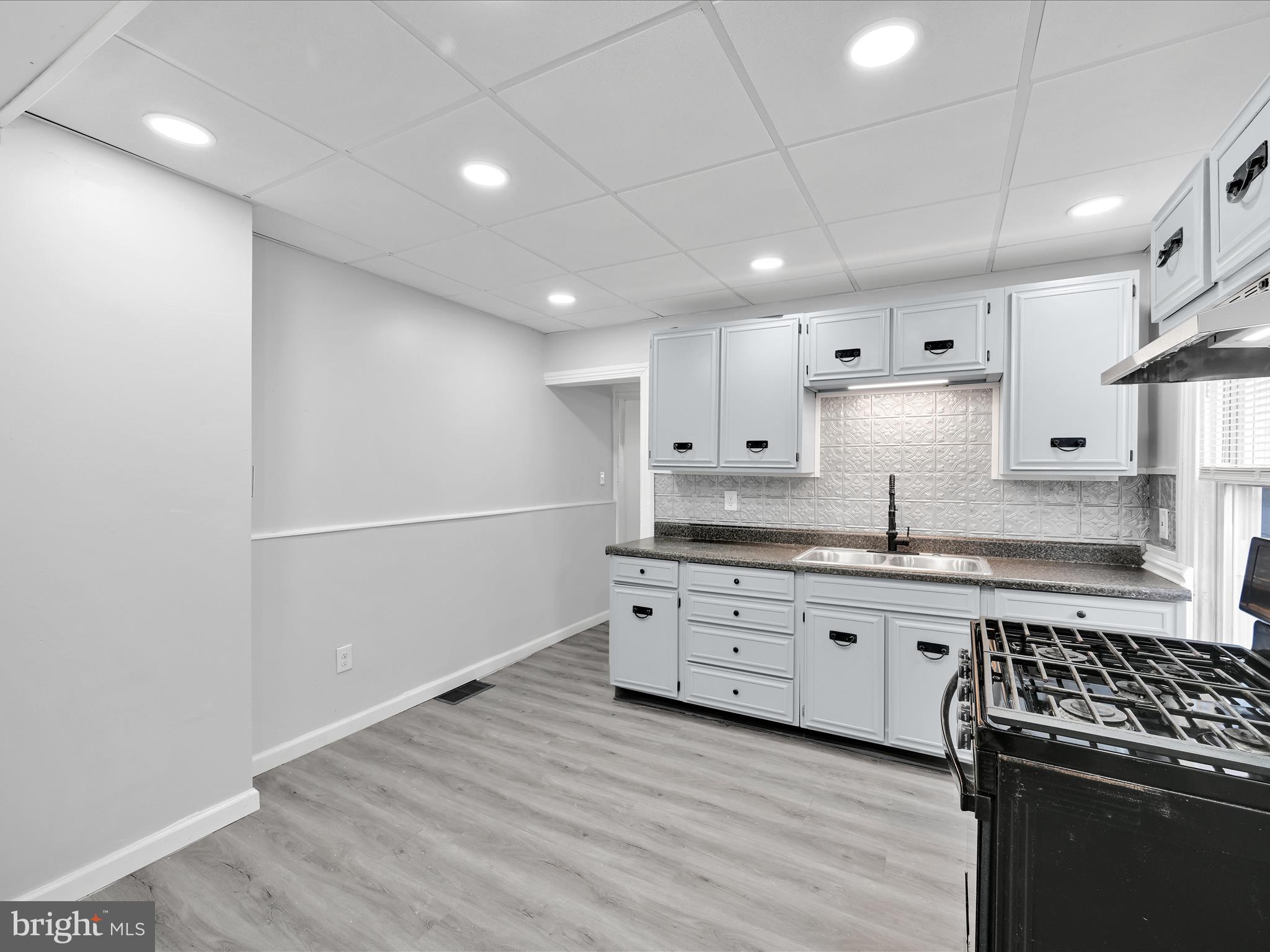 1253 Green Street Reading, PA 19604 - Photo 12 of 26 a kitchen with granite countertop a sink cabinets and stainless steel appliances