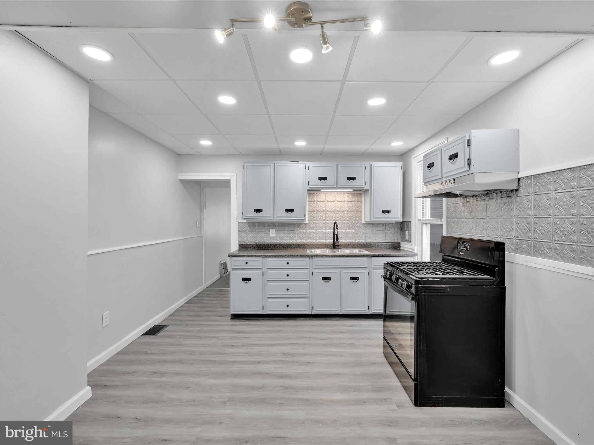 1253 Green Street Reading, PA 19604 - Photo 14 of 26 a large kitchen with stainless steel appliances granite countertop a stove a sink and a refrigerator