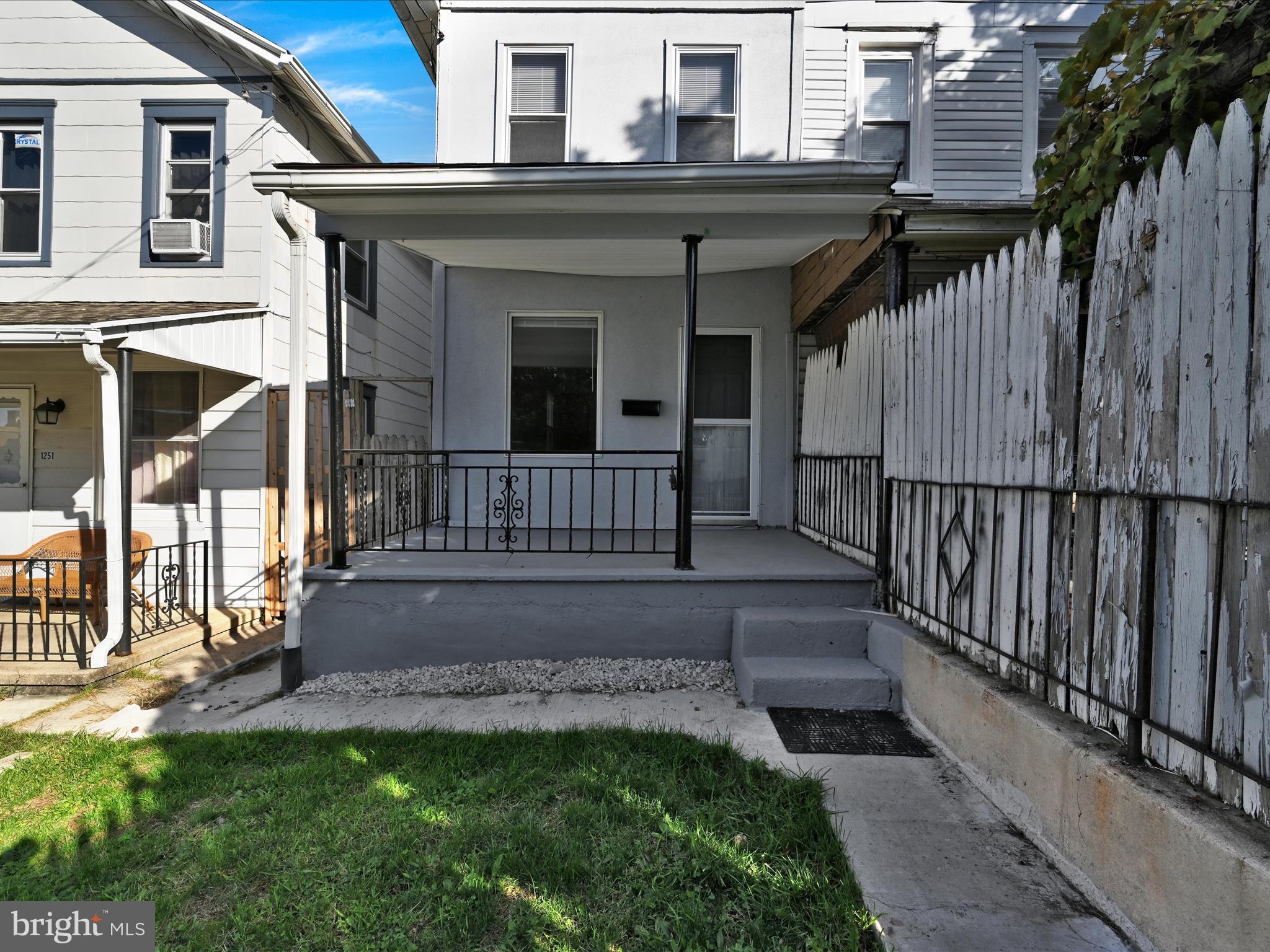 1253 Green Street Reading, PA 19604 - Photo 3 of 26 a view of a house with a small yard and wooden fence