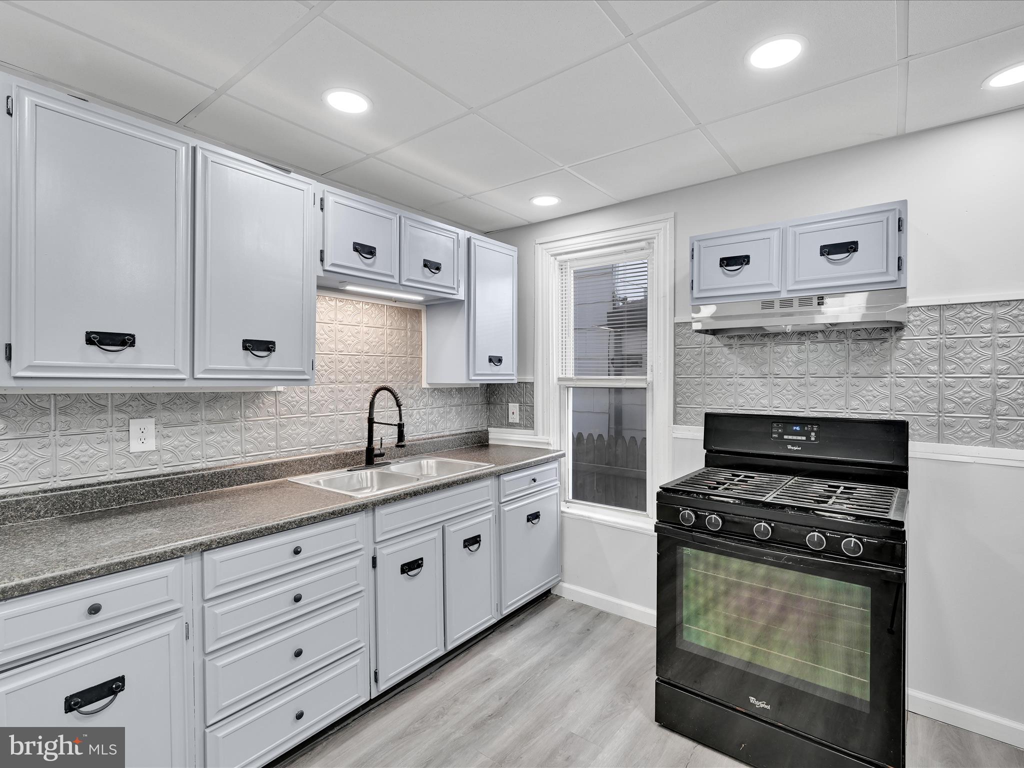 1253 Green Street Reading, PA 19604 - Photo 10 of 26 a kitchen with granite countertop a stove and a sink