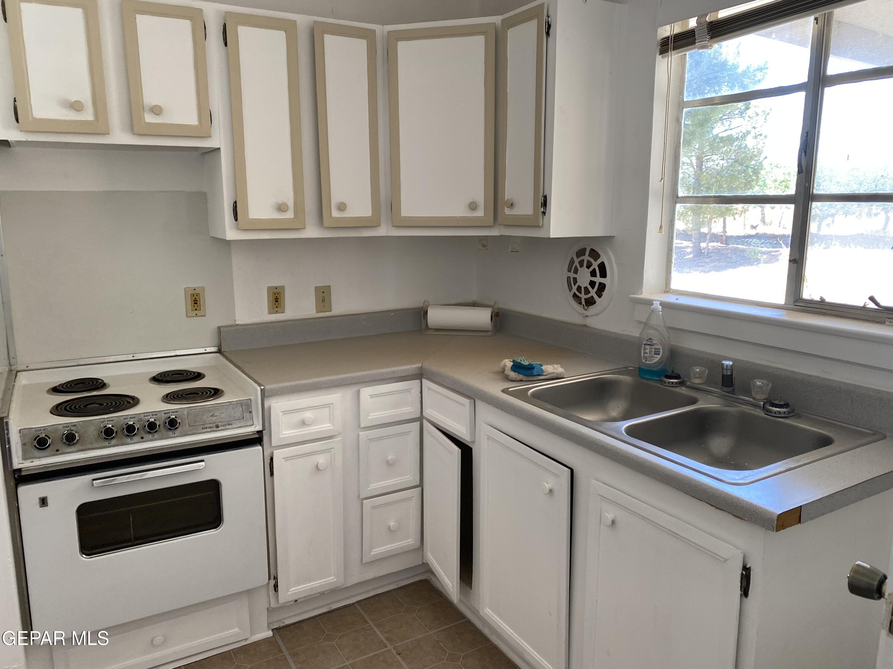 2695 Redstone Street Chaparral, NM 88081 - Photo 18 of 33 a kitchen with white cabinets sink and appliances
