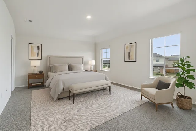 a bedroom with a bed and a couch