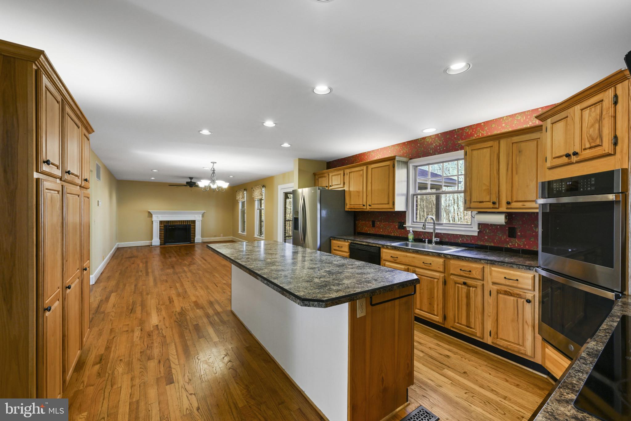 16966 Teagues Point Road Hughesville, MD 20637 - Photo 72 of 72 a kitchen with stainless steel appliances granite countertop a sink stove and refrigerator
