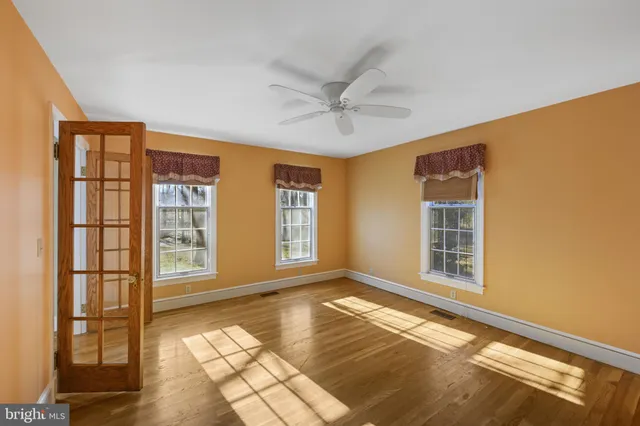 an empty room with a white walls and entryway