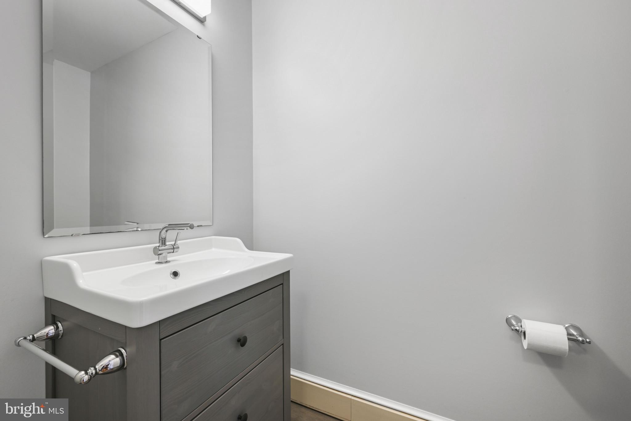 16966 Teagues Point Road Hughesville, MD 20637 - Photo 14 of 72 a bathroom with a sink and a mirror