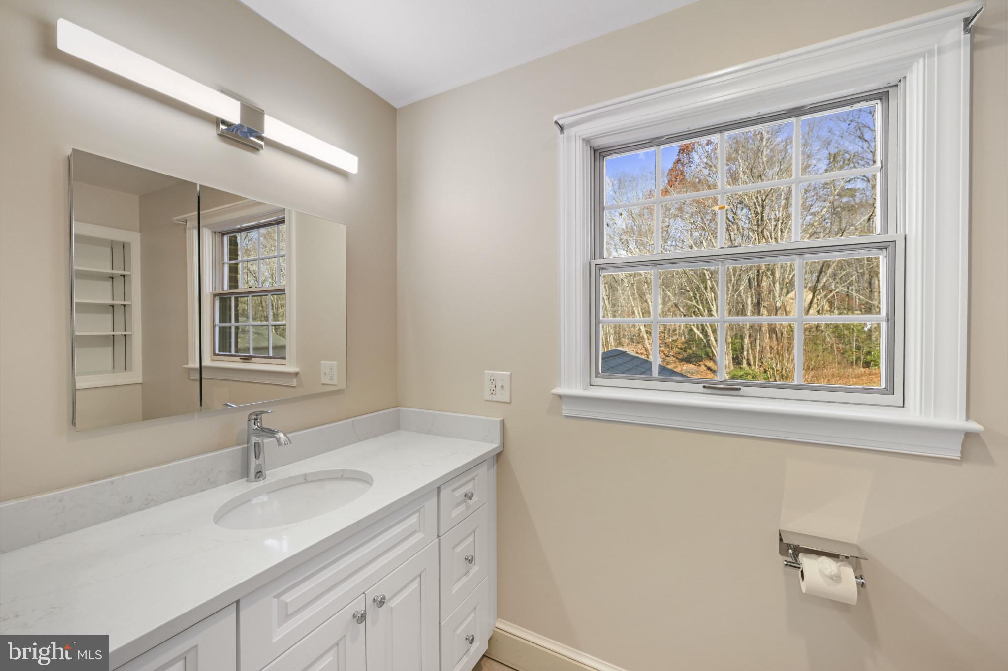 16966 Teagues Point Road Hughesville, MD 20637 - Photo 18 of 72 Bathroom with vanity and baseboards