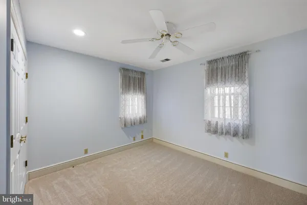a bathroom with a granite countertop sink a toilet and a mirror