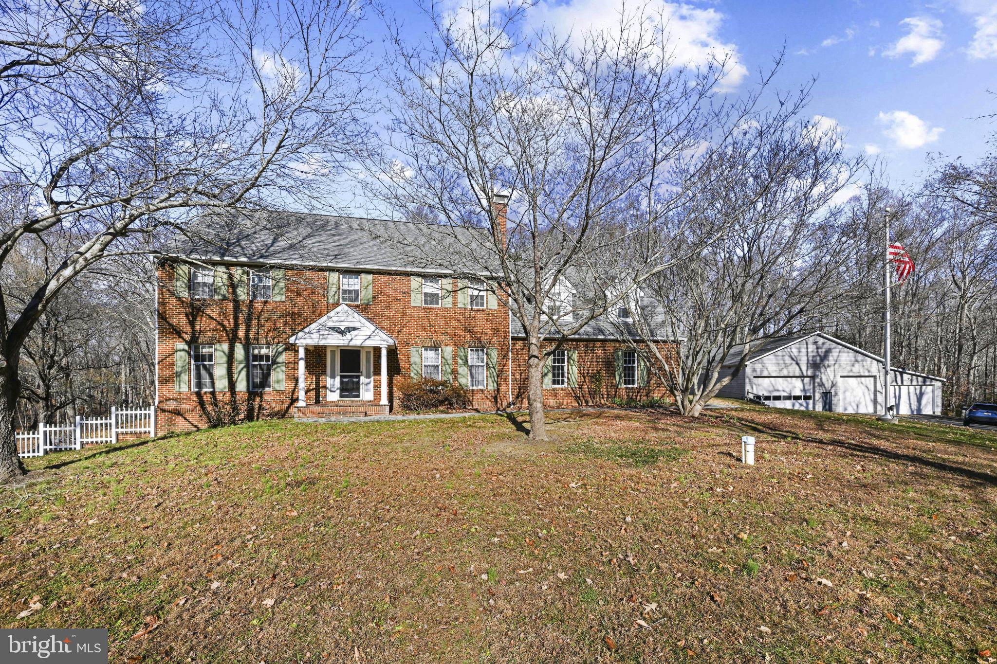 16966 Teagues Point Road Hughesville, MD 20637 - Photo 2 of 72 Colonial house with brick siding and a garage