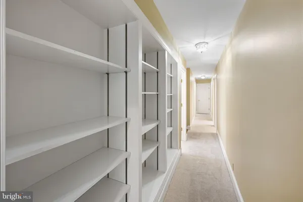 an empty room with a white walls and entryway