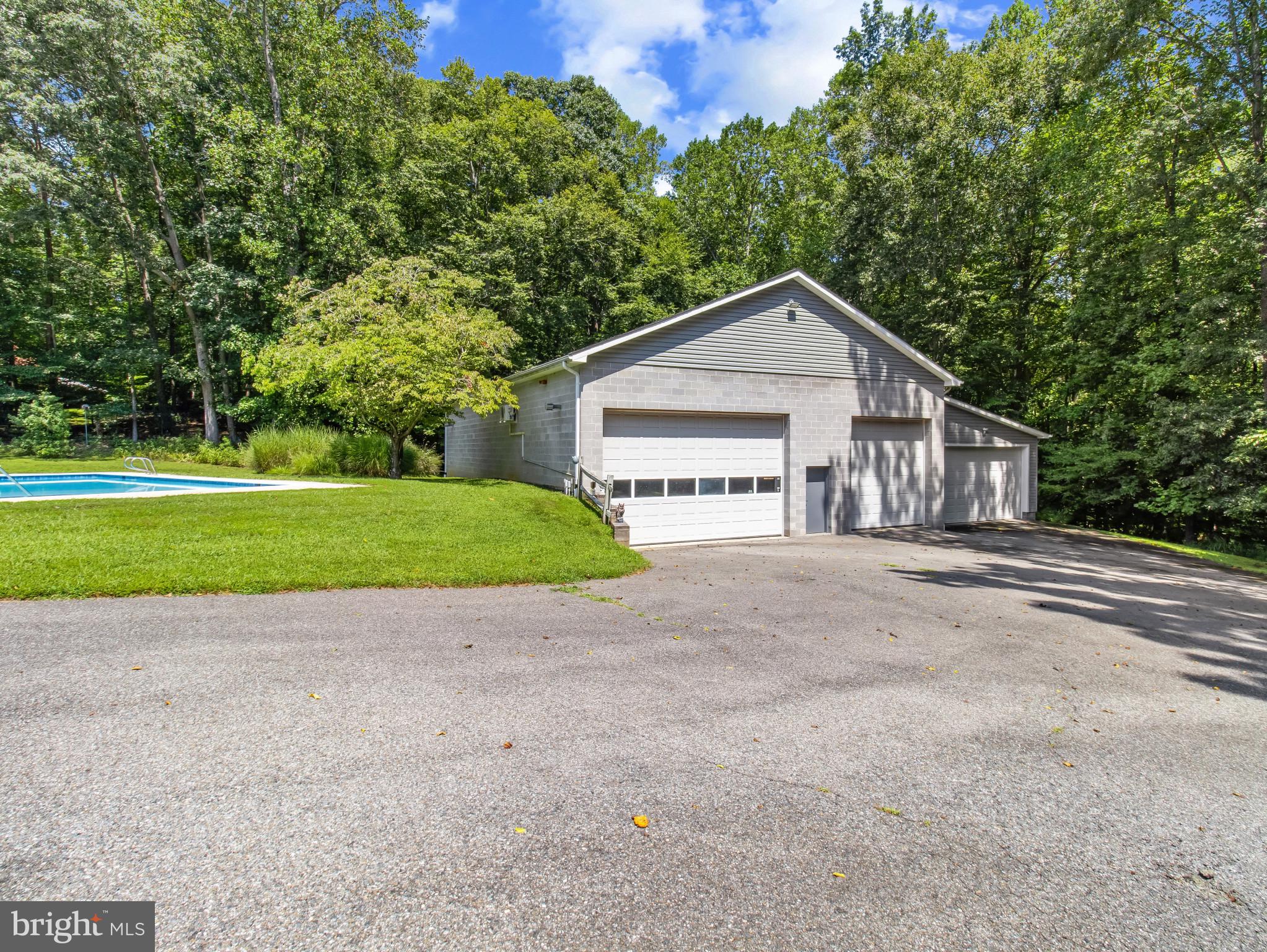 16966 Teagues Point Road Hughesville, MD 20637 - Photo 43 of 72 a house with a small yard and large trees