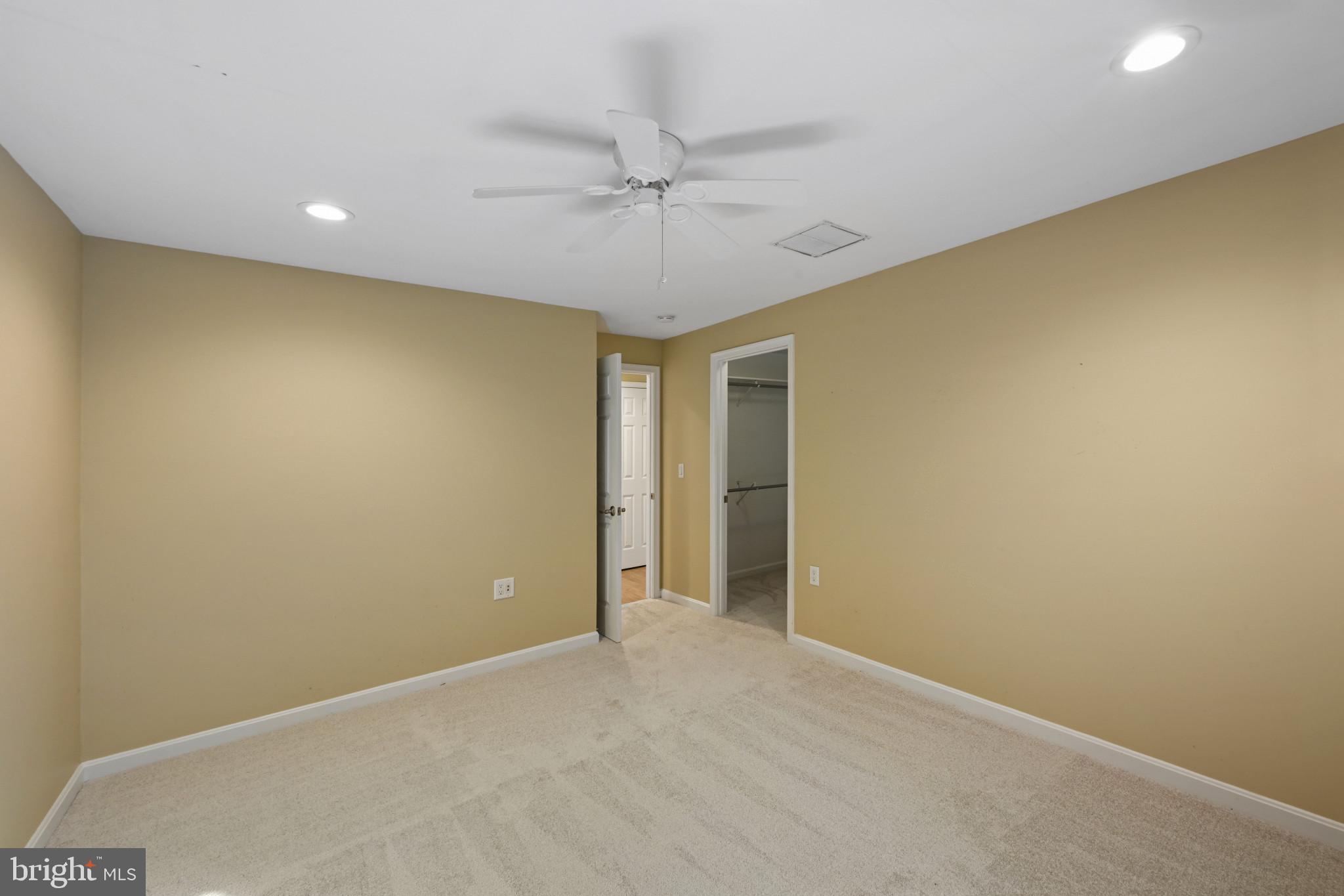 16966 Teagues Point Road Hughesville, MD 20637 - Photo 61 of 72 an empty room with a ceiling fan and a window