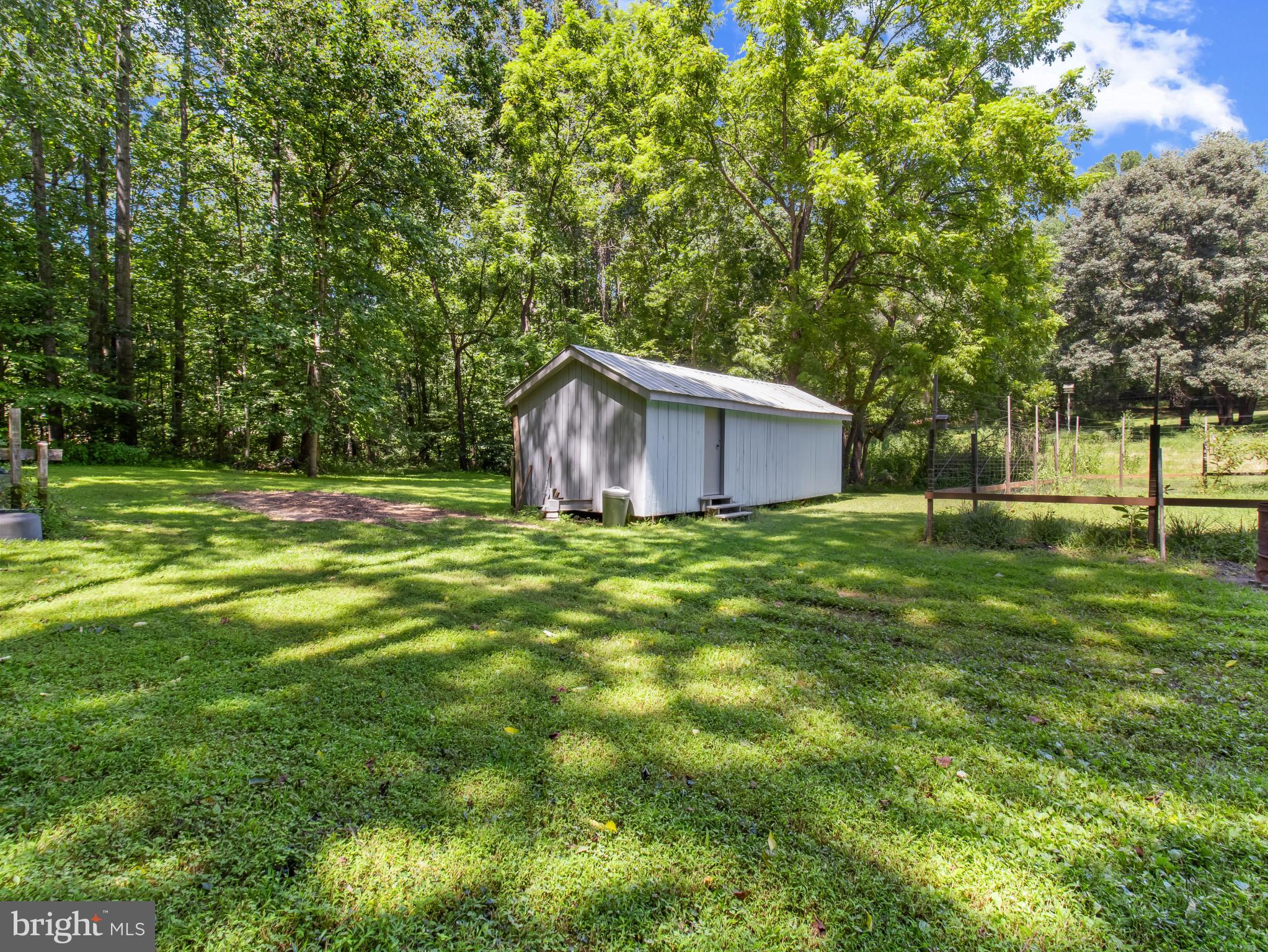 16966 Teagues Point Road Hughesville, MD 20637 - Photo 66 of 72 a backyard of a house with lots of green space and fountain