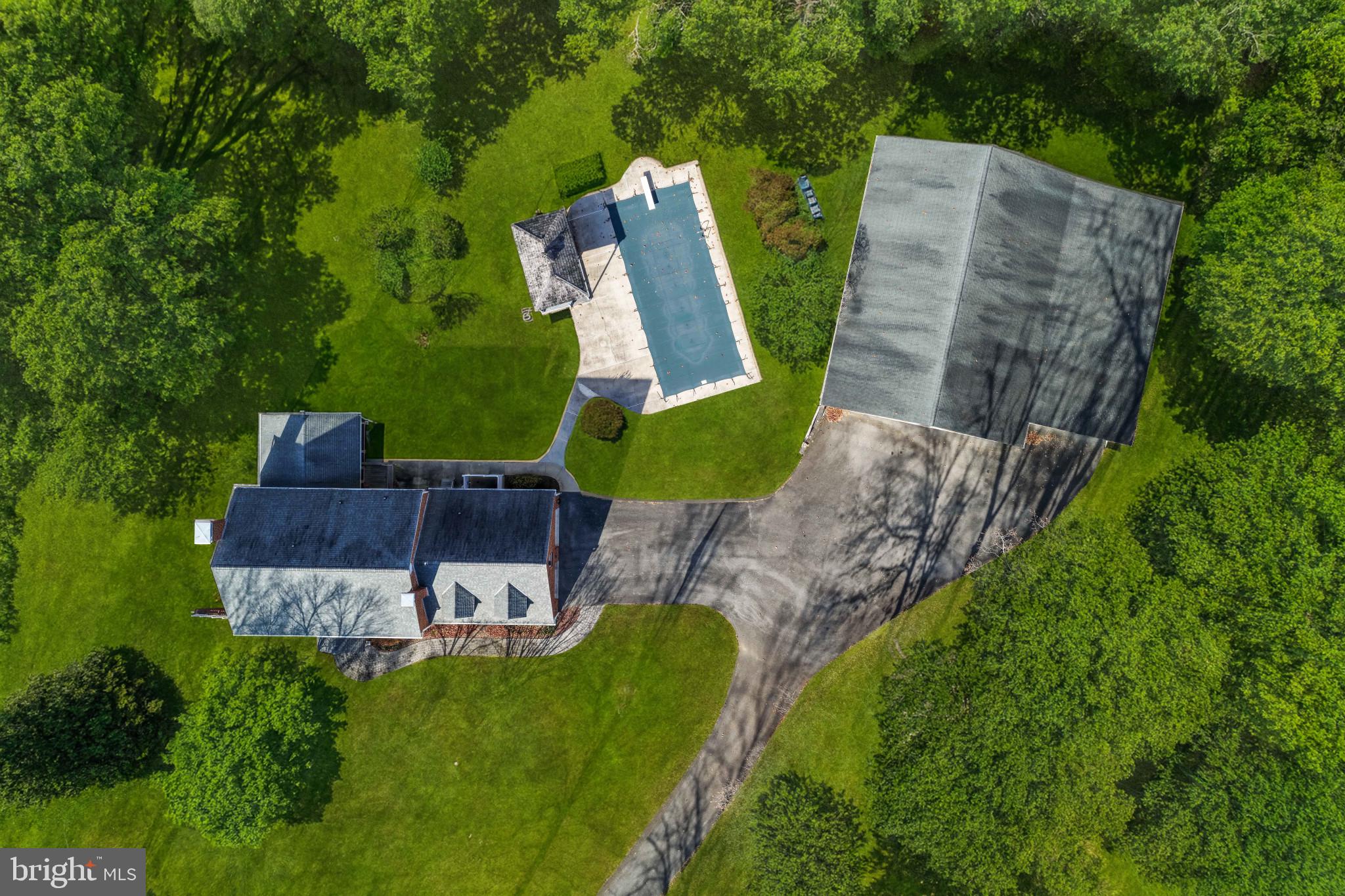 16966 Teagues Point Road Hughesville, MD 20637 - Photo 67 of 72 an aerial view of a house with a yard and large trees