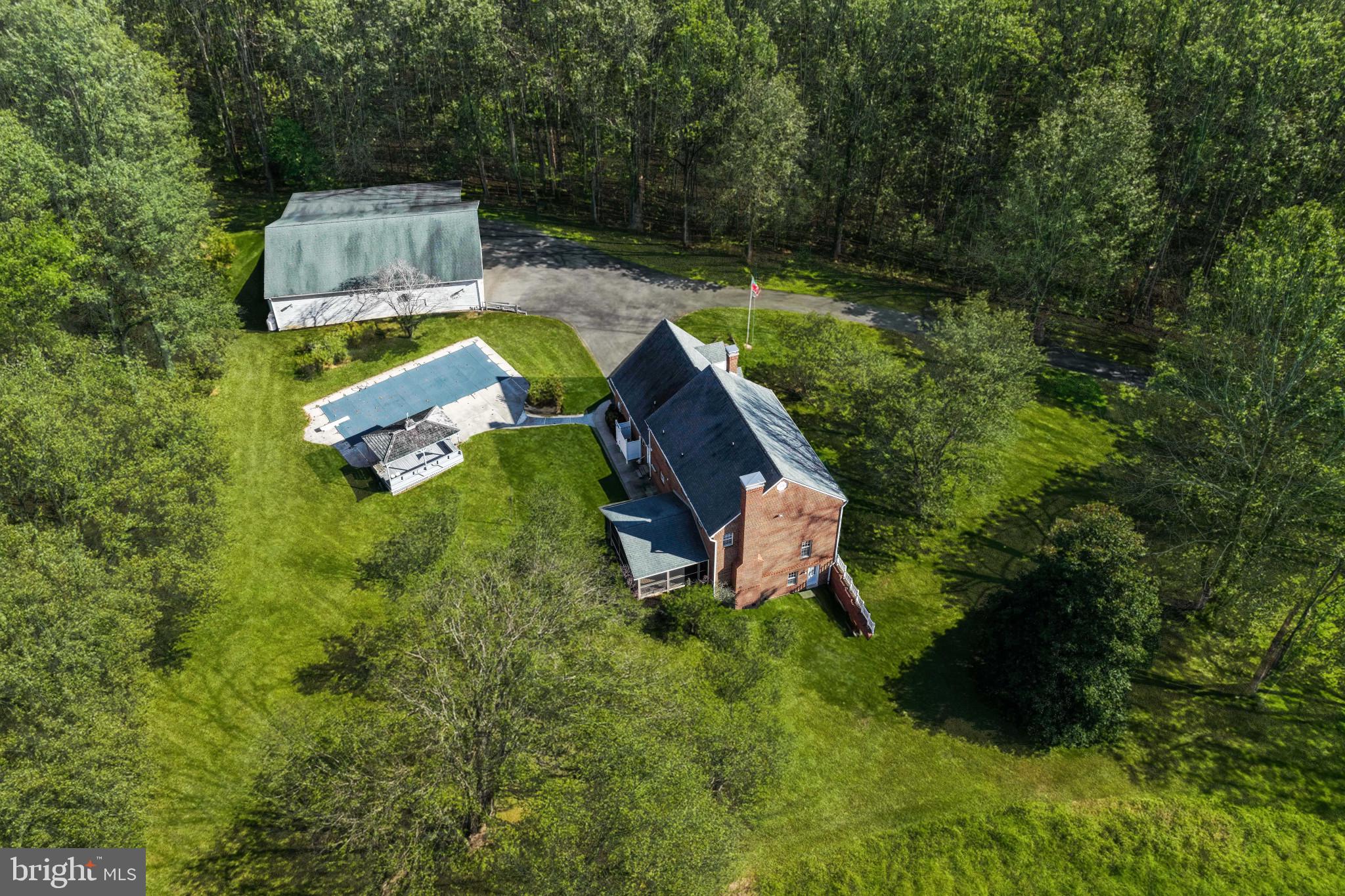 16966 Teagues Point Road Hughesville, MD 20637 - Photo 70 of 72 a aerial view of a house with a yard and lake view