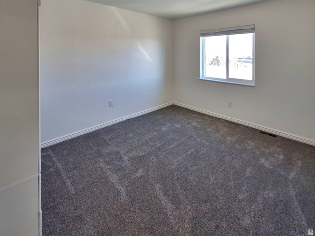 1510 South Lawrence Road Huntington, UT 84528 - Photo 7 of 16 Carpeted interior room with white walls, white trim, and a double-pane window