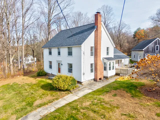 a view of a house with a yard patio and fire pit