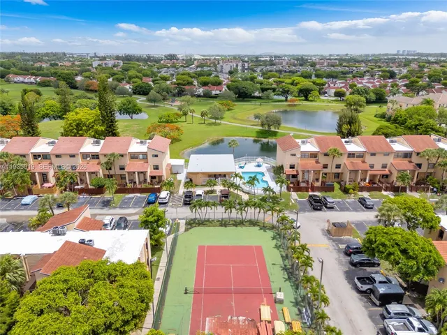 an aerial view of a house with a swimming pool outdoor seating and yard