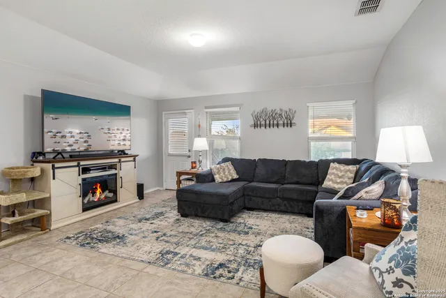 a living room with furniture and a flat screen tv