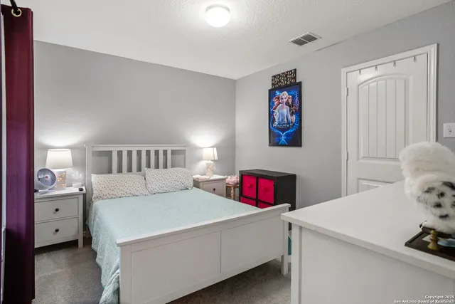 a bedroom with a bed and a cabinets