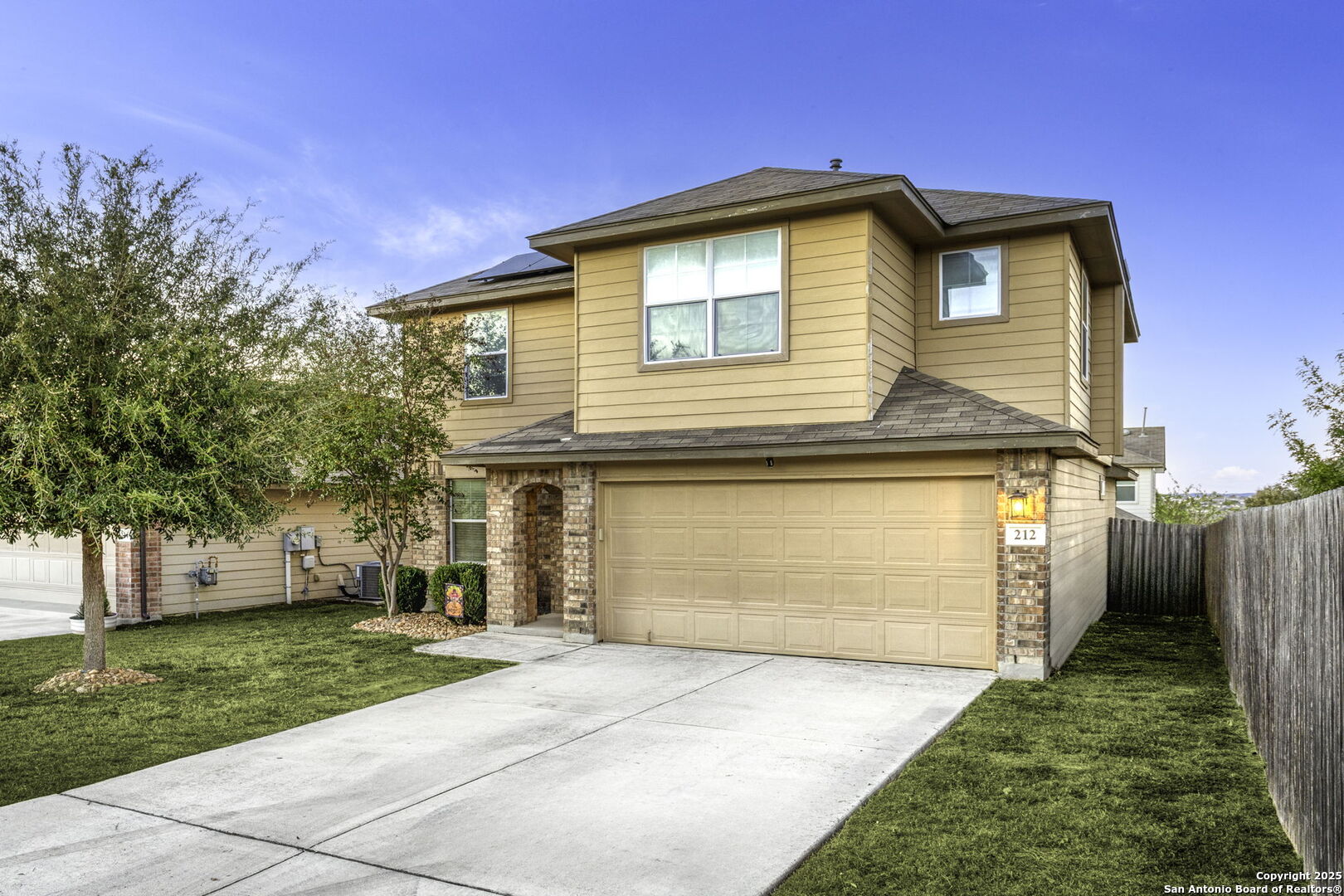 212 Kildeer Creek San Antonio, TX 78253 - Photo 2 of 29 a front view of a house with a yard and garage