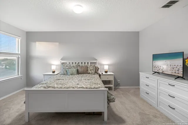 a bed sitting in a bedroom and window