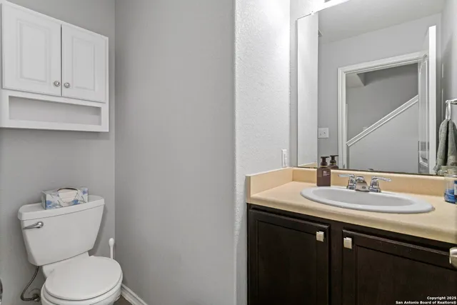 a bathroom with a toilet sink and mirror