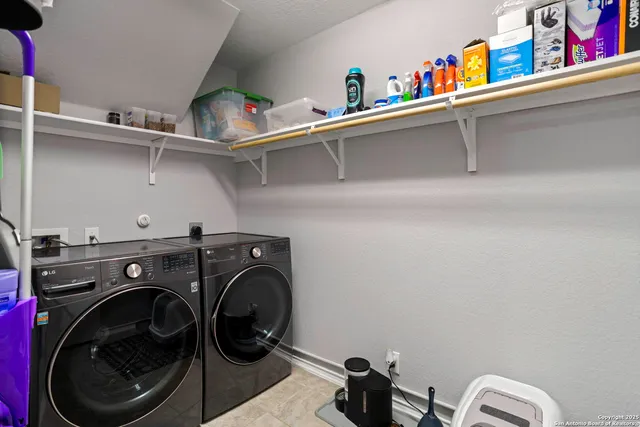 a utility room with dryer washer and other items