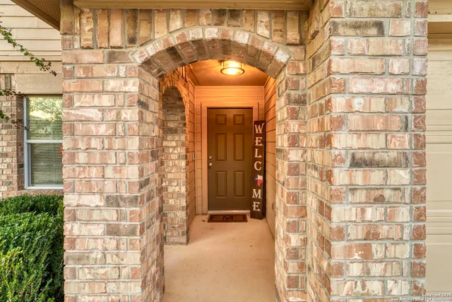 a view of a brick wall with a glass door