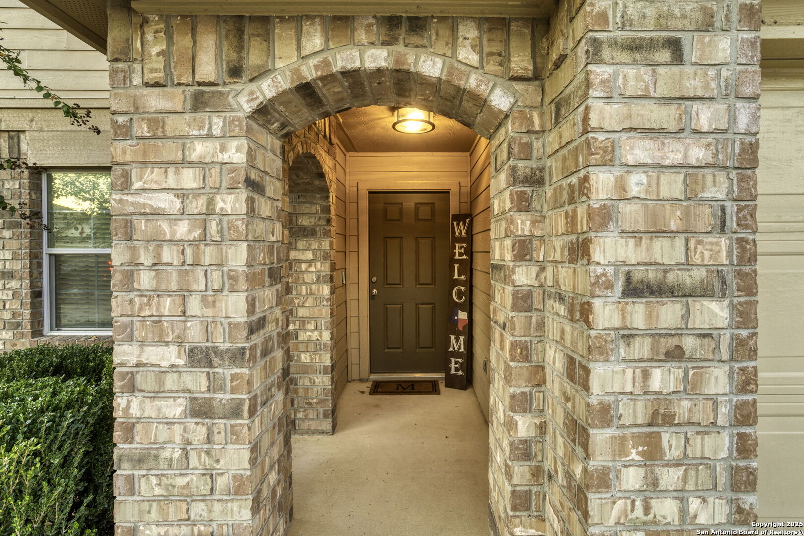 212 Kildeer Creek San Antonio, TX 78253 - Photo 3 of 29 a view of a brick wall with a glass door