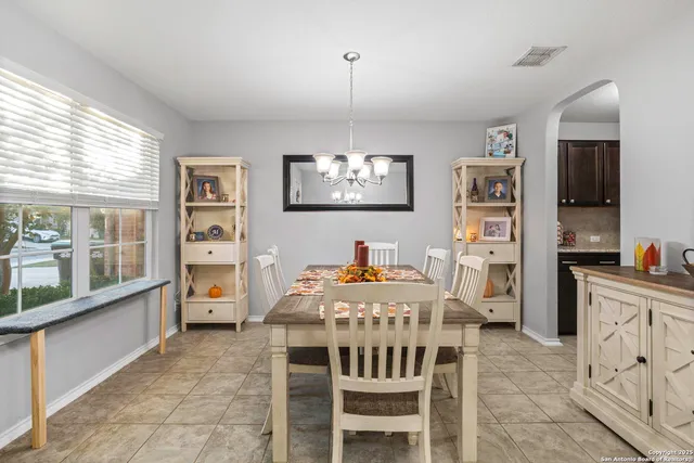 a view of a dining room with furniture and window