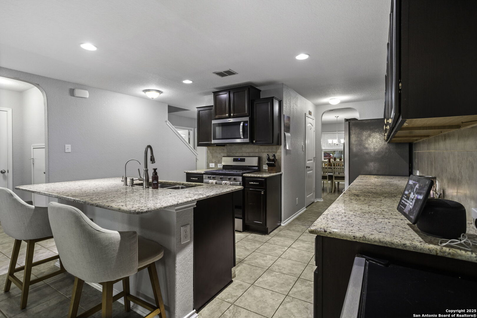 212 Kildeer Creek San Antonio, TX 78253 - Photo 9 of 29 a kitchen with kitchen island granite countertop a sink and stainless steel appliances