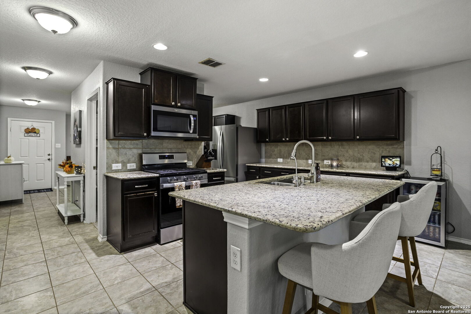 212 Kildeer Creek San Antonio, TX 78253 - Photo 10 of 29 a kitchen with stainless steel appliances granite countertop a sink refrigerator and cabinets