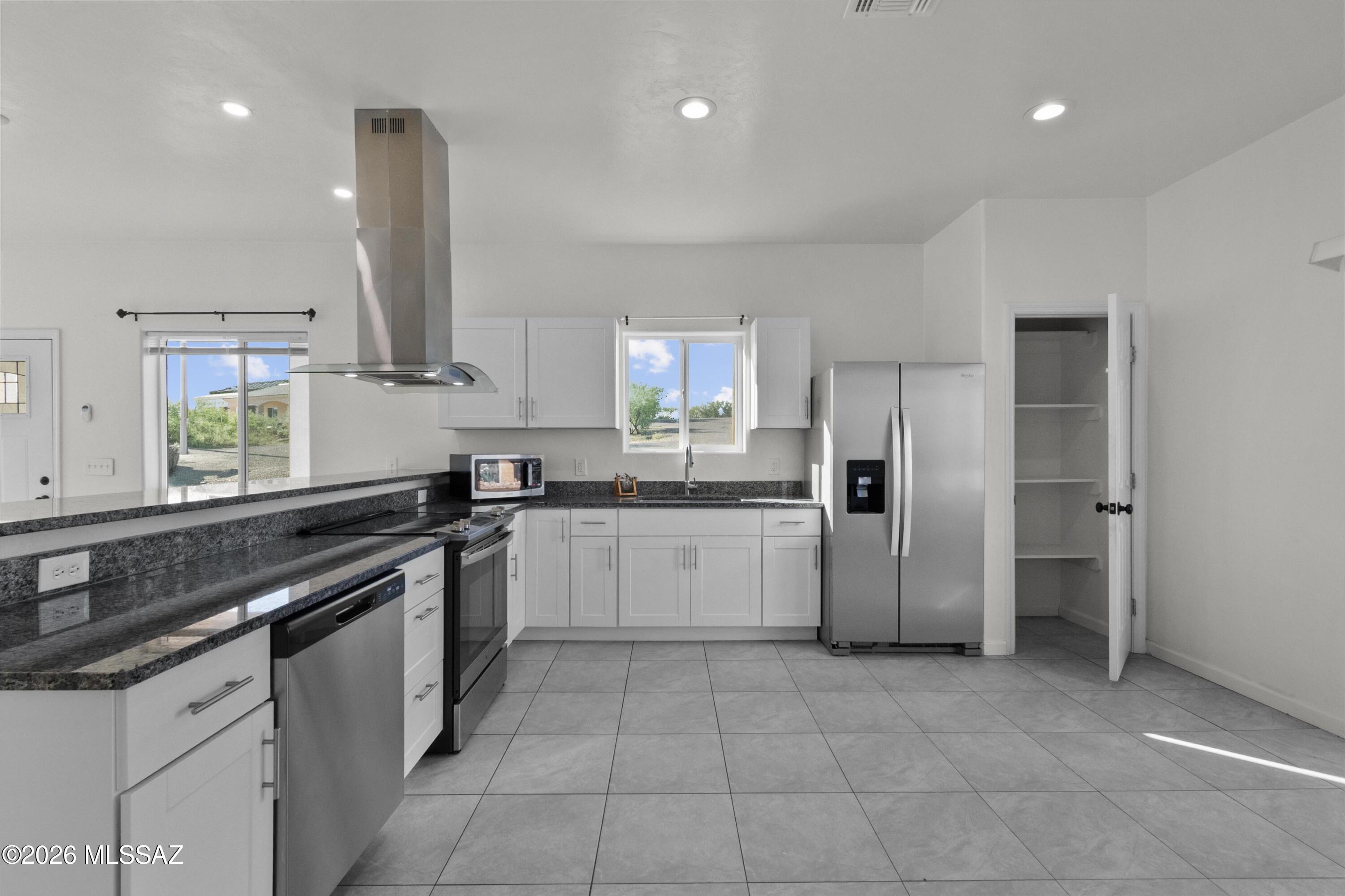 1785 Dove Court Rio Rico, AZ 85648 - Photo 11 of 31 a kitchen with a sink a refrigerator and window